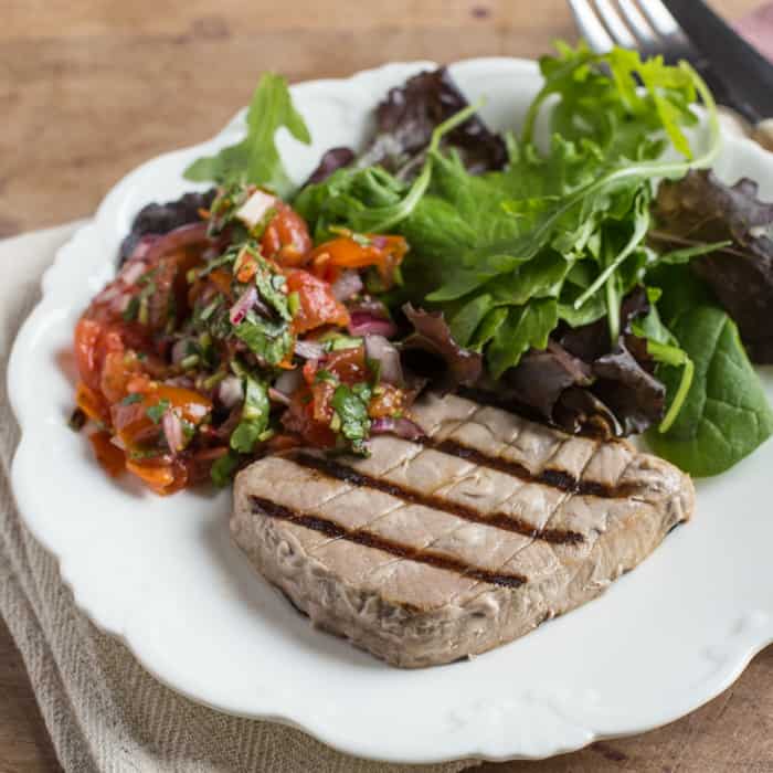 White plate with griddled tuna and salad