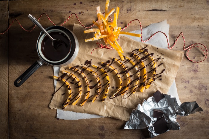 Freshly made Candied Orange Peel being drizzled with melted dark chocolate