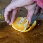 Removing the peel from an orange to make Candied Orange Peel