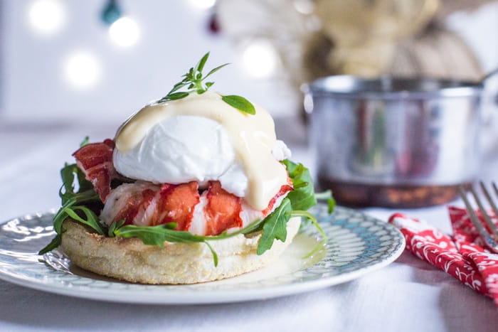 Lagosta Ovos Benedict em um prato de porcelana com as decorações de natal