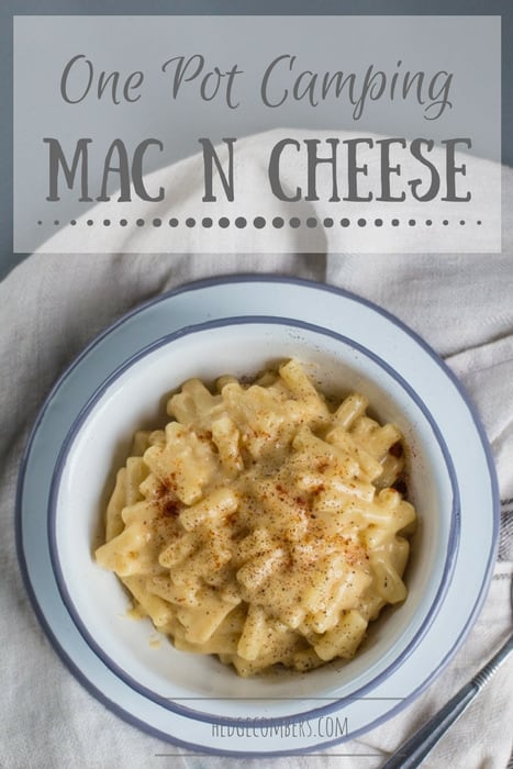 Simple white bowl of homemade mac and cheese with a muted grey background