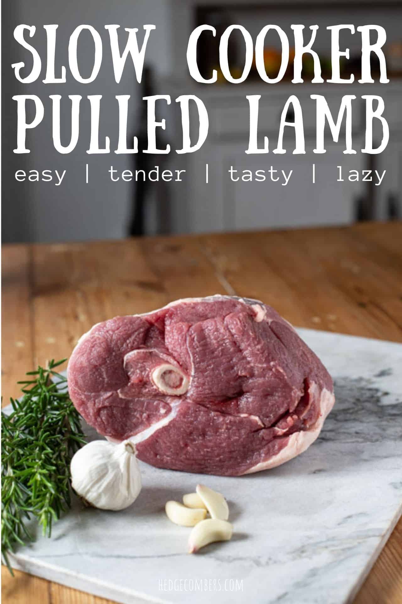 wopden kitchen counter with marble slab garlic bulb, herbs and fresh leg of lamb