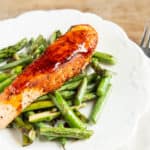 White plate with salmon fillet and asparagus stir fry