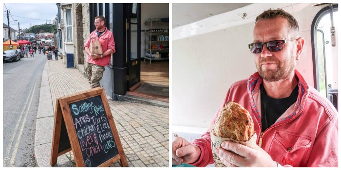 Man holding bag of Cornish pasties outside a pasty shop in Porthleven, Cornwall and tasting a pasty