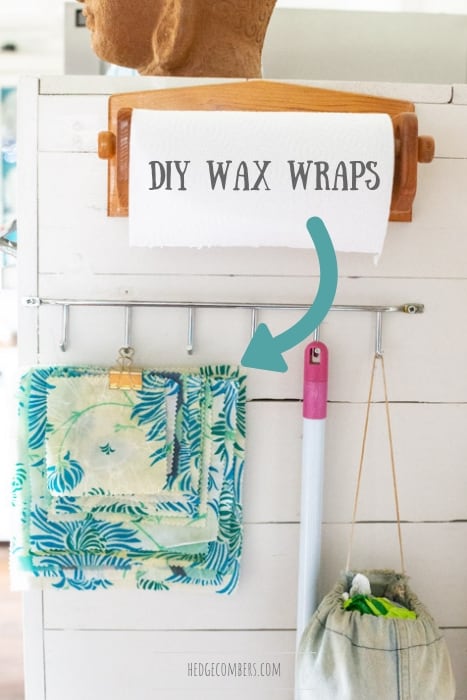white kitchen wall with a broom handle and pack of diy beeswax wraps hanging from a gold bulldog clip