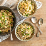 wooden board with 3 bowls filled with my easy chicken biryani recipe