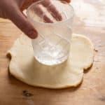 shaping pork pie pastry around a crystal cut glass