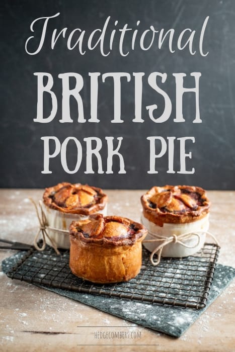 3 handmade British pork pies cooling on a wire rack over a wooden board