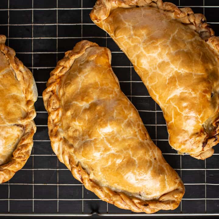 black background with blue cloth and golden Cornish pasty