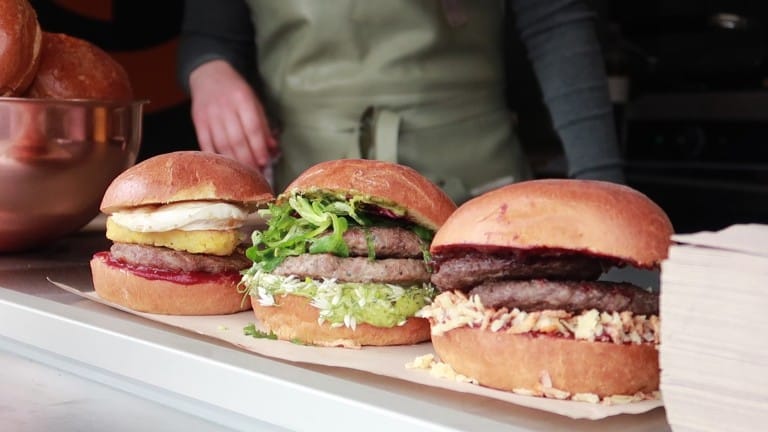 3 burgers lined up on a street food stall at the Porthleven Food Festival 2019