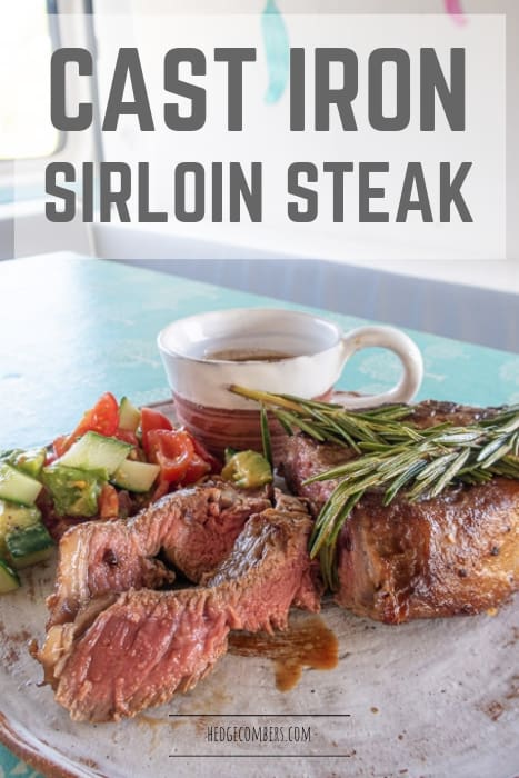 white plate on blue table with a juicy sliced sirloin steak and salad