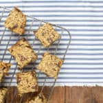 healthy banana flapjack squares on a metal cooling rack on top of stripey fabric