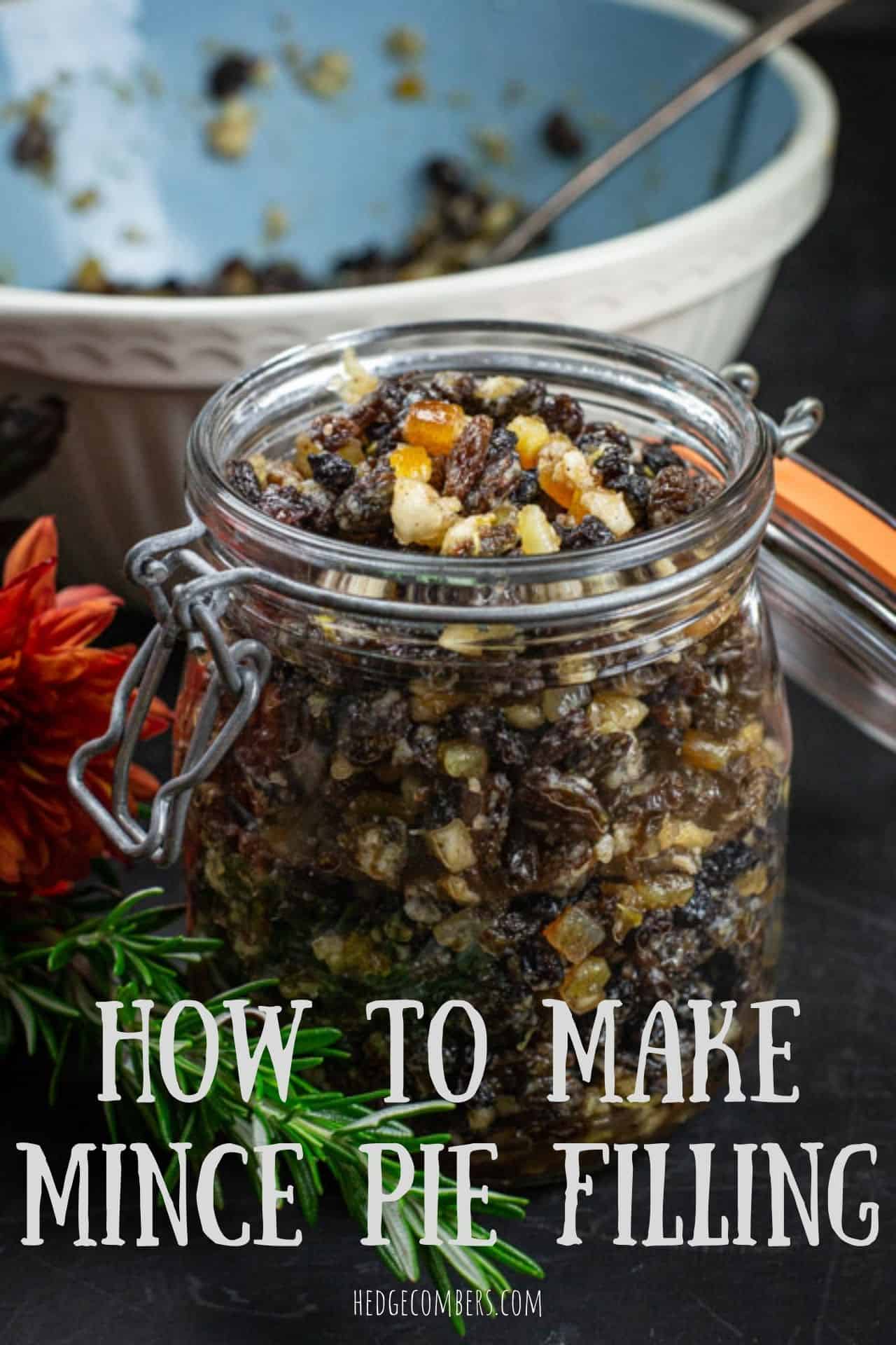 glass jar filled with fruity mincemeat filling on a kitchen counter with baking mess around