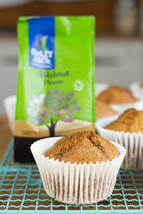 Muffins made using Pumpkin Spice Muffins recipe sat on cooling tray with bag of ingredients in the background