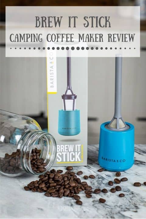 grey and blue plastic camping coffee maker laid out on marble surface with coffee beans and glass jar