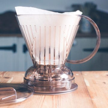 clever dripper coffee maker with paper filter on a wooden kitchen counter