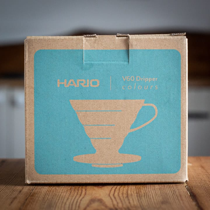 brown and turquoise box for the Hario v60 coffee maker on wooden surface