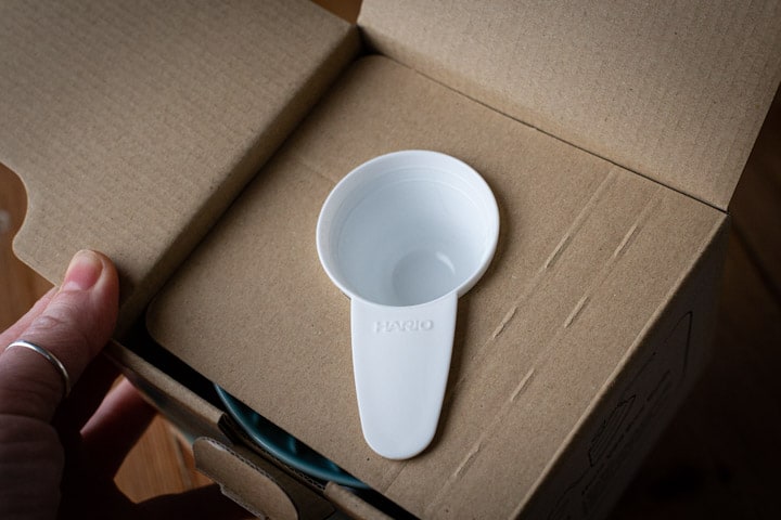 white coffee scoop within the cardboard packaging of the hario v60 box