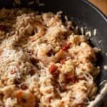 juicy pink prawn in a pan of chorizo risotto