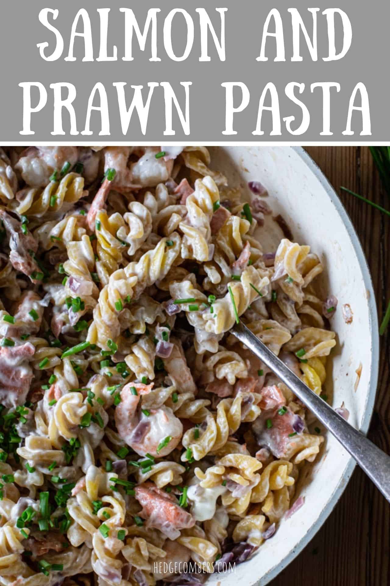 white pan with salmon prawn ad fusilli pasta in a creamy sauce