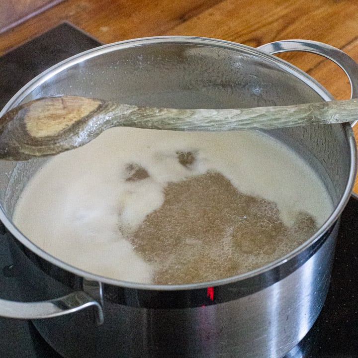 elderflower jam bubbling in a large silver saucepan