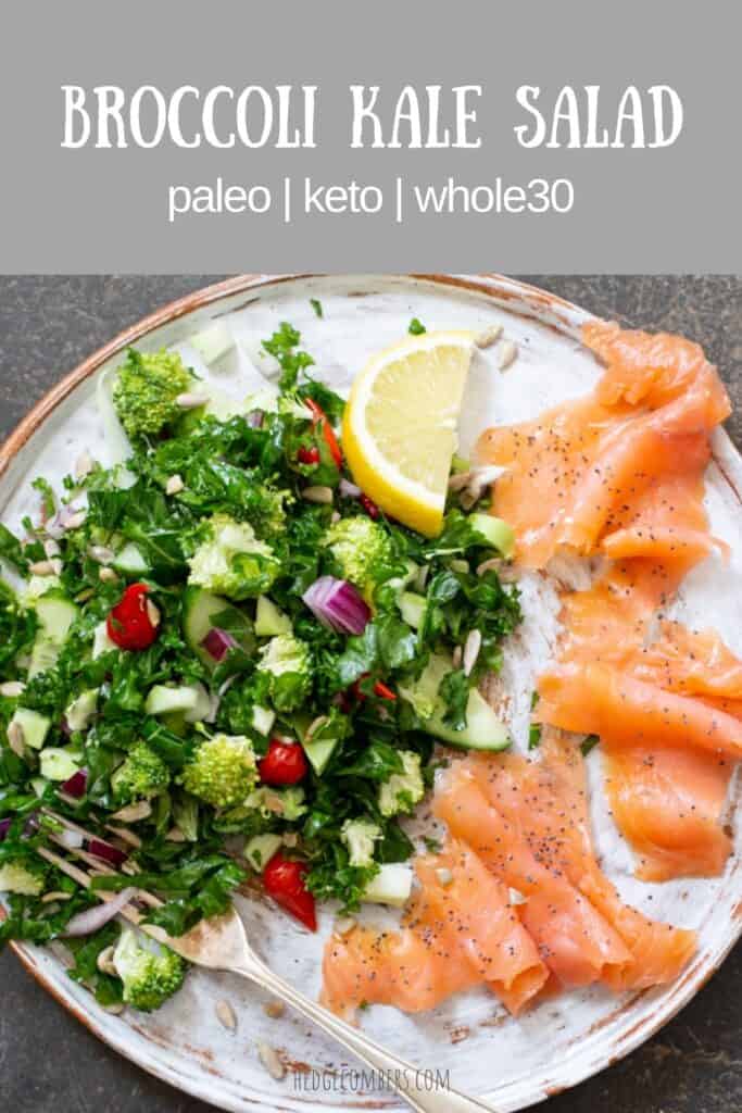 White plate with bright green broccoli kale salad, lemon slice and smoked salmon slices