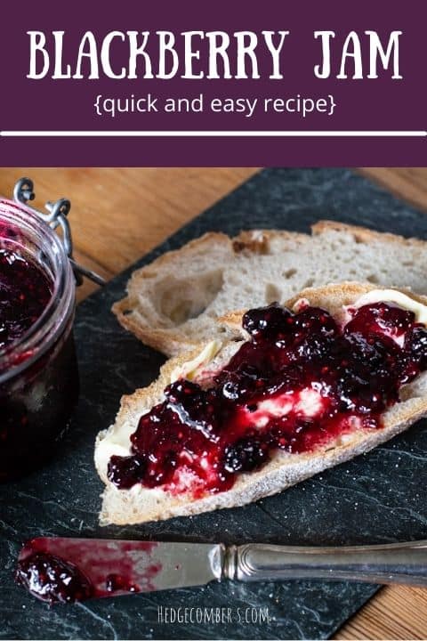 Dark grey piece of slate with 2 slices of fresh sourdough bread topped with home made blackberry jam