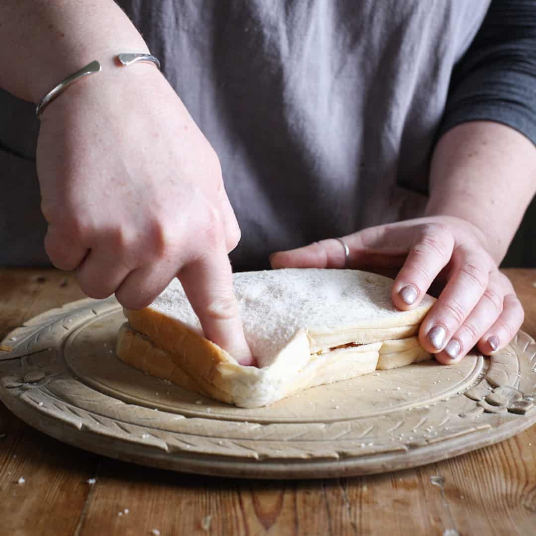 Pressing together the edges of the sandwich