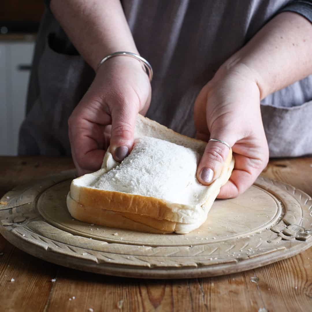 Woman sealing the edges of the uncooked toasty